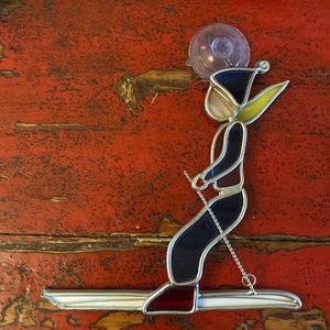 Stained glass window art. Blue and red skier.